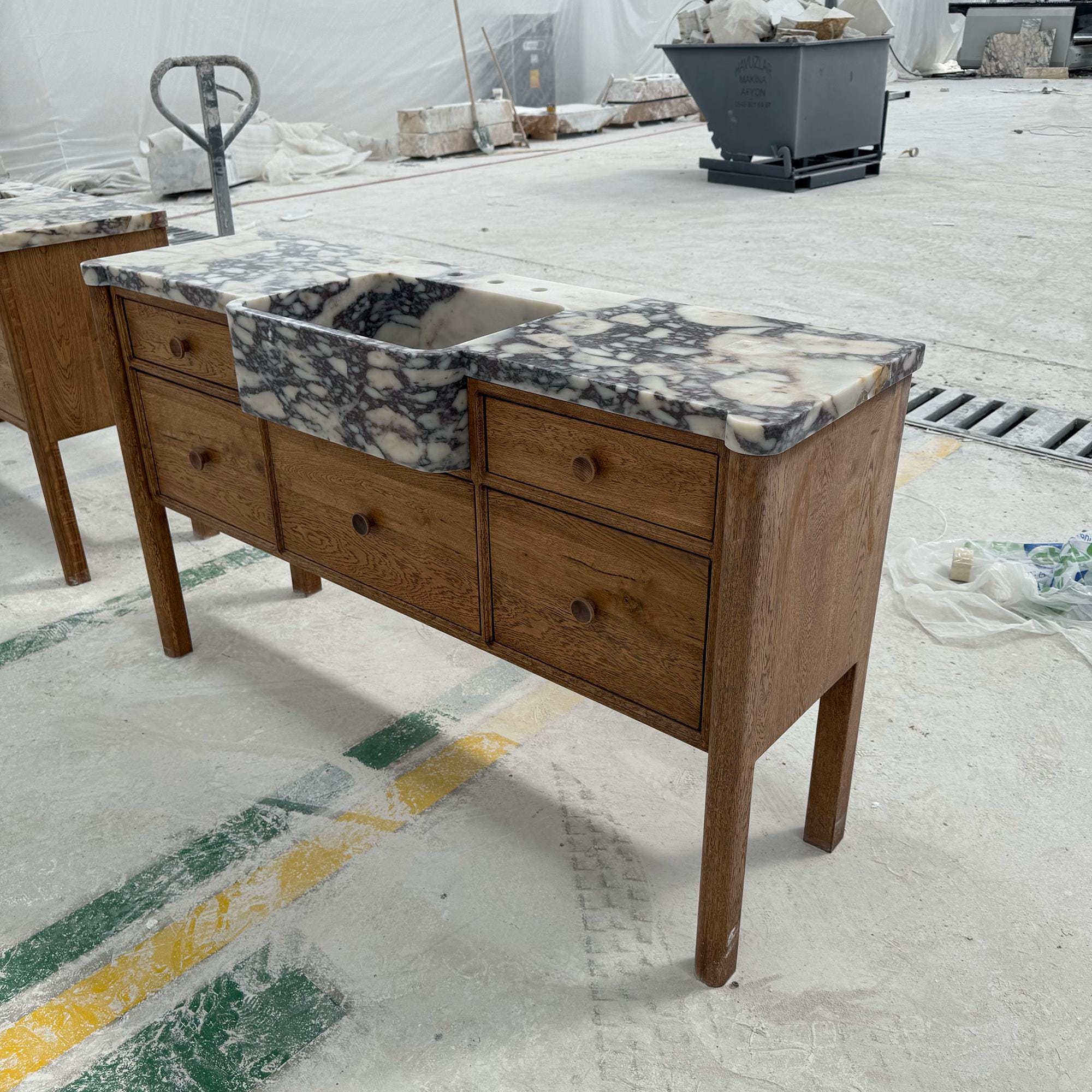 calacatta viola marble sink with wood drawers